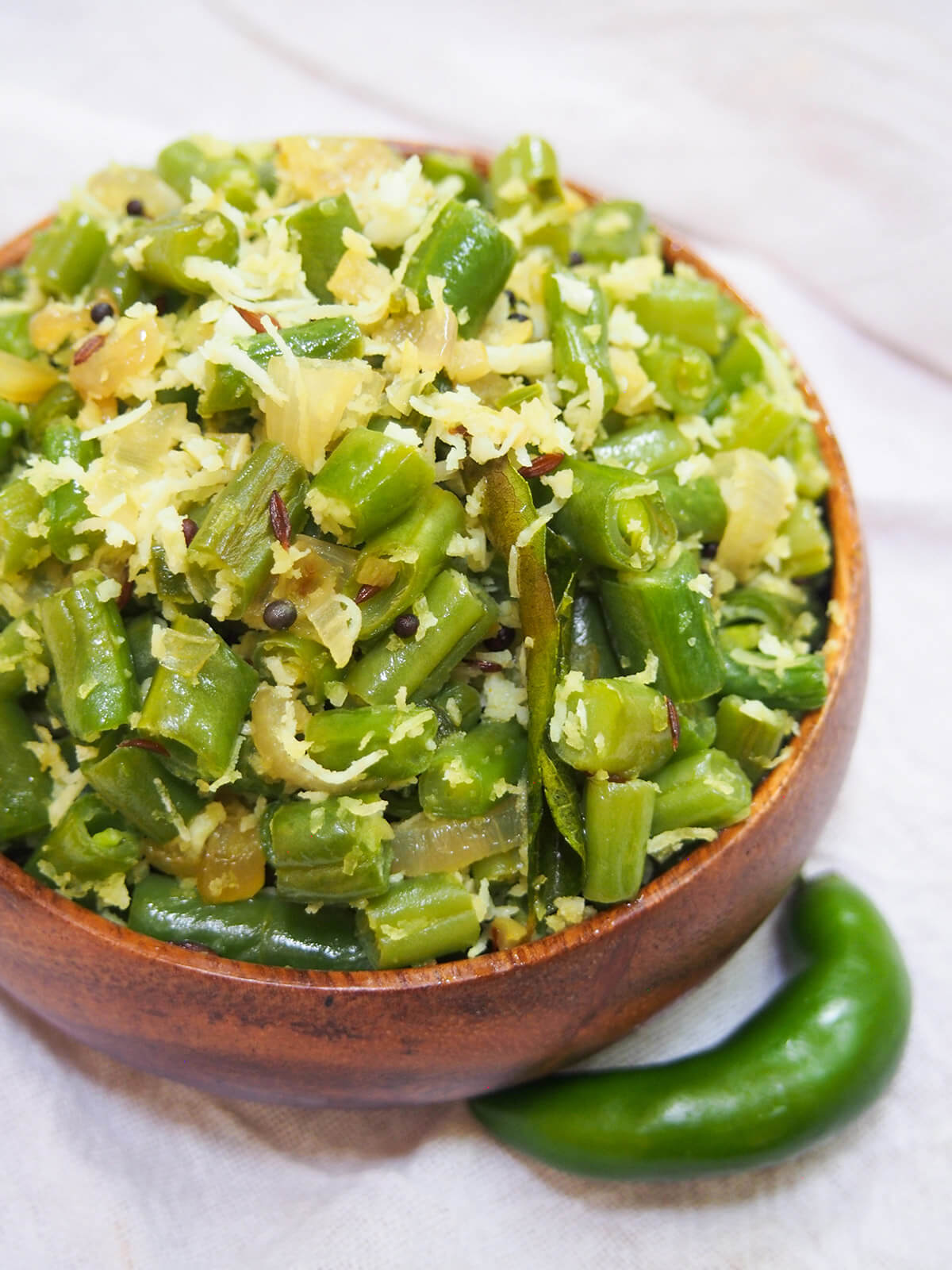 bowl of beans thoran from overhead with chili to side