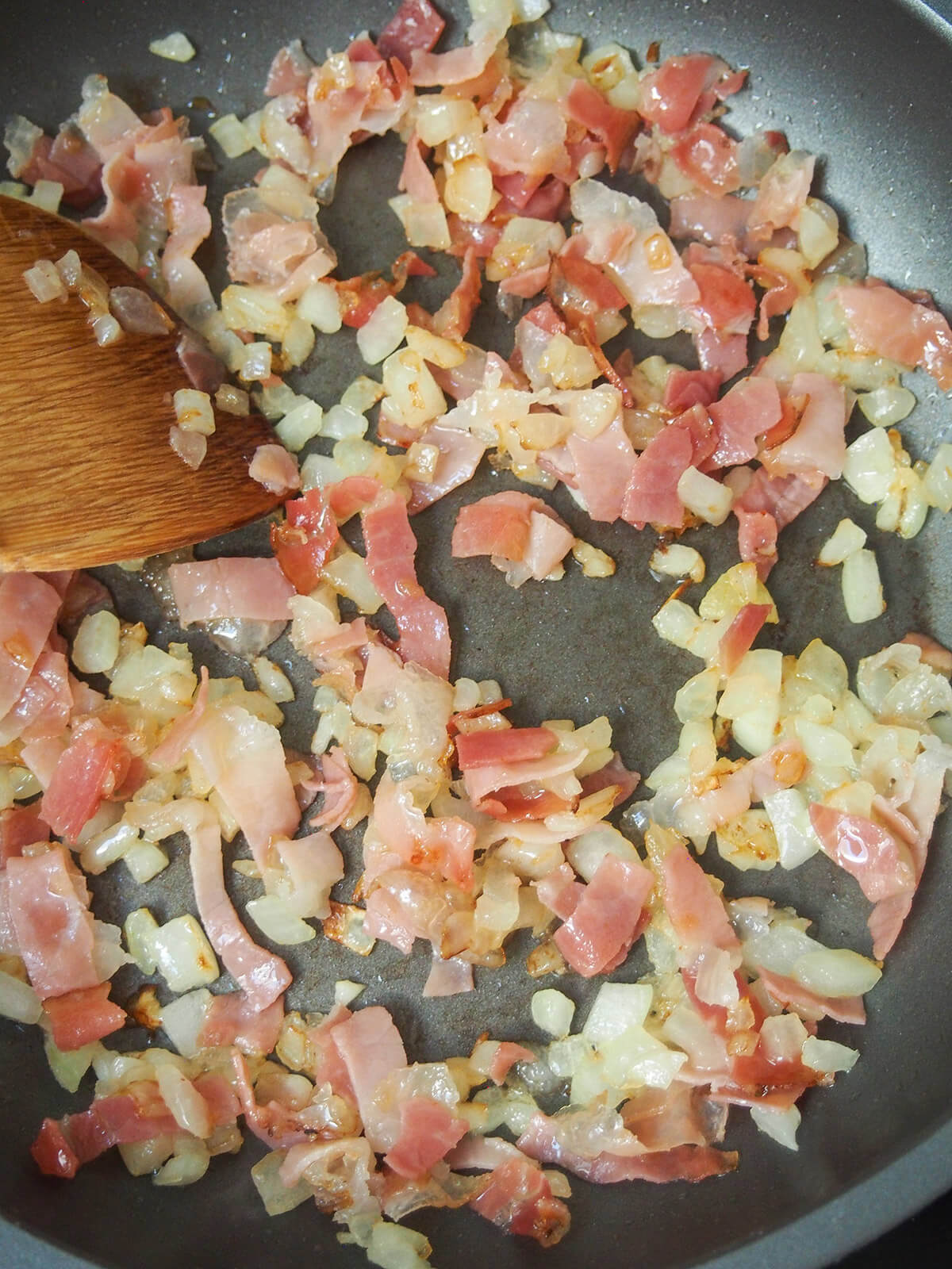 cooking speck and onion in skillet