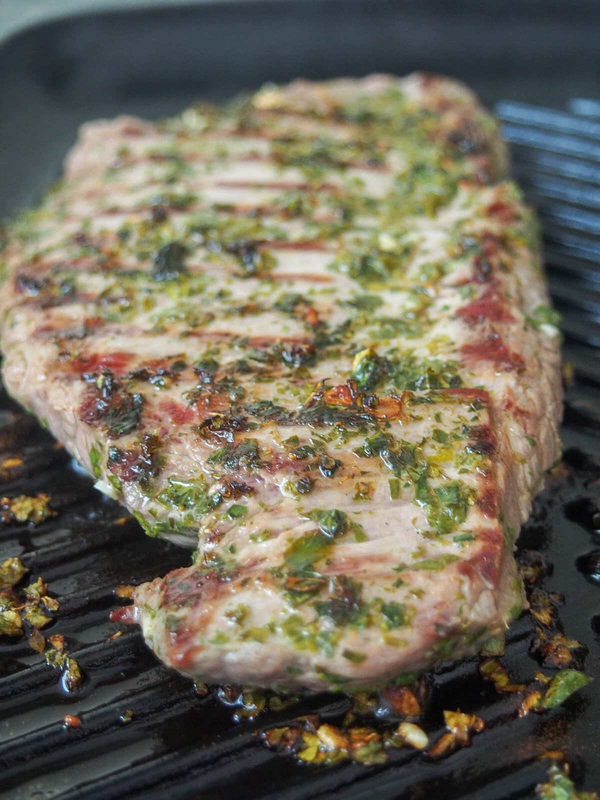 cooking chimichurri marinated steak steak with chimichurri marinade cooking on grill pan