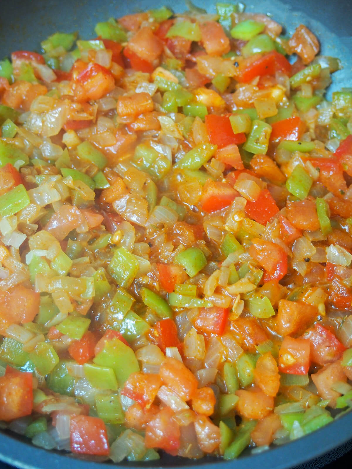 tomato, pepper and onion in skillet