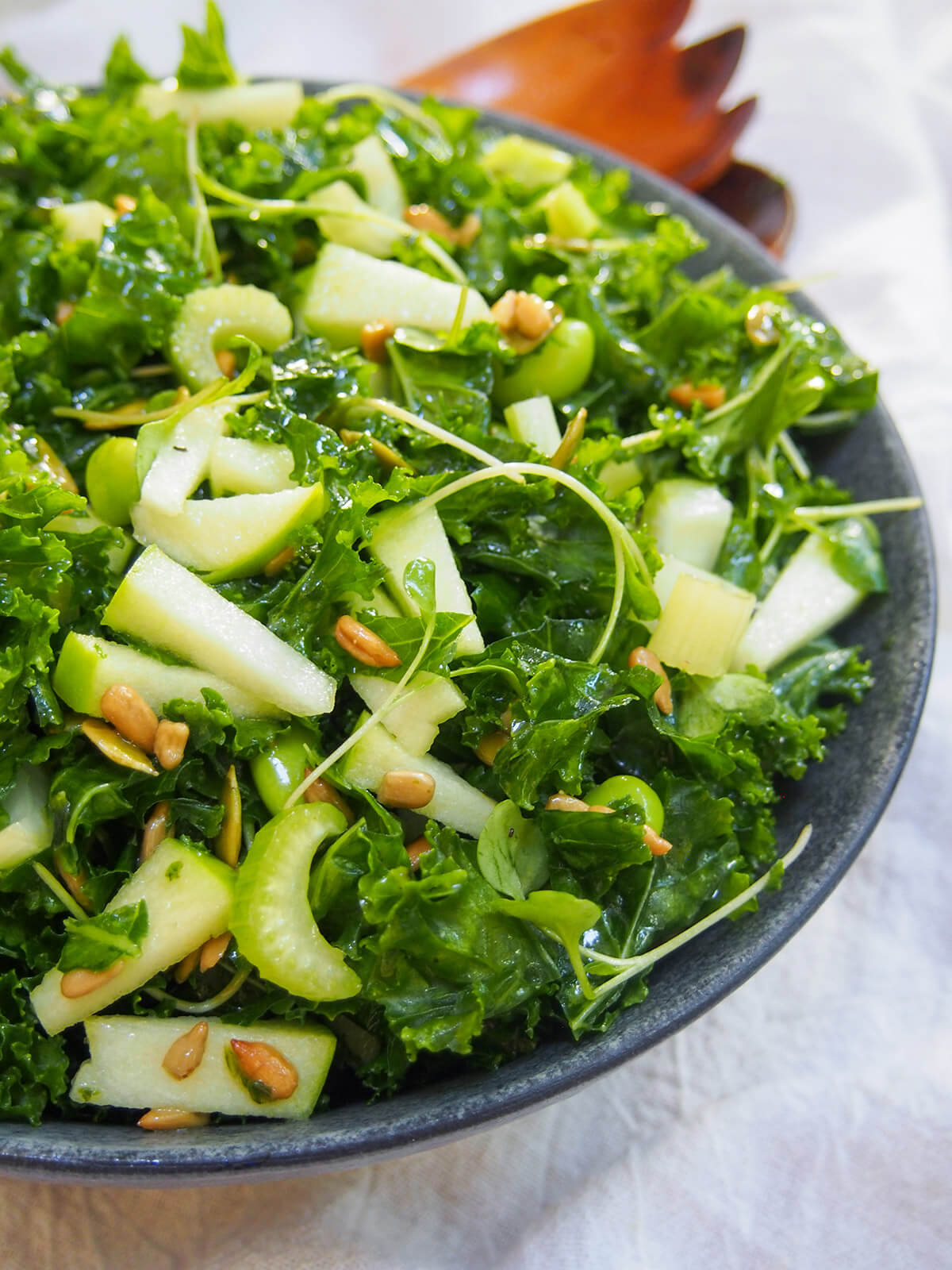 side view of bowl of apple kale salad
