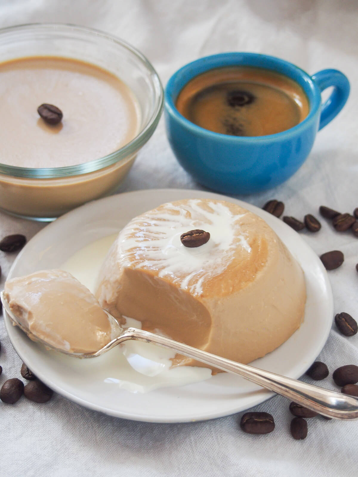 coffee panna cotta on plate with a scoop taken out on spoon