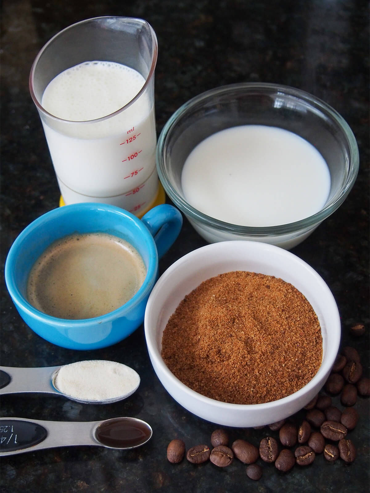 dishes with milk, cream, coconut sugar and an espresso shot in cut plus spoons with gelatin and vanilla to side