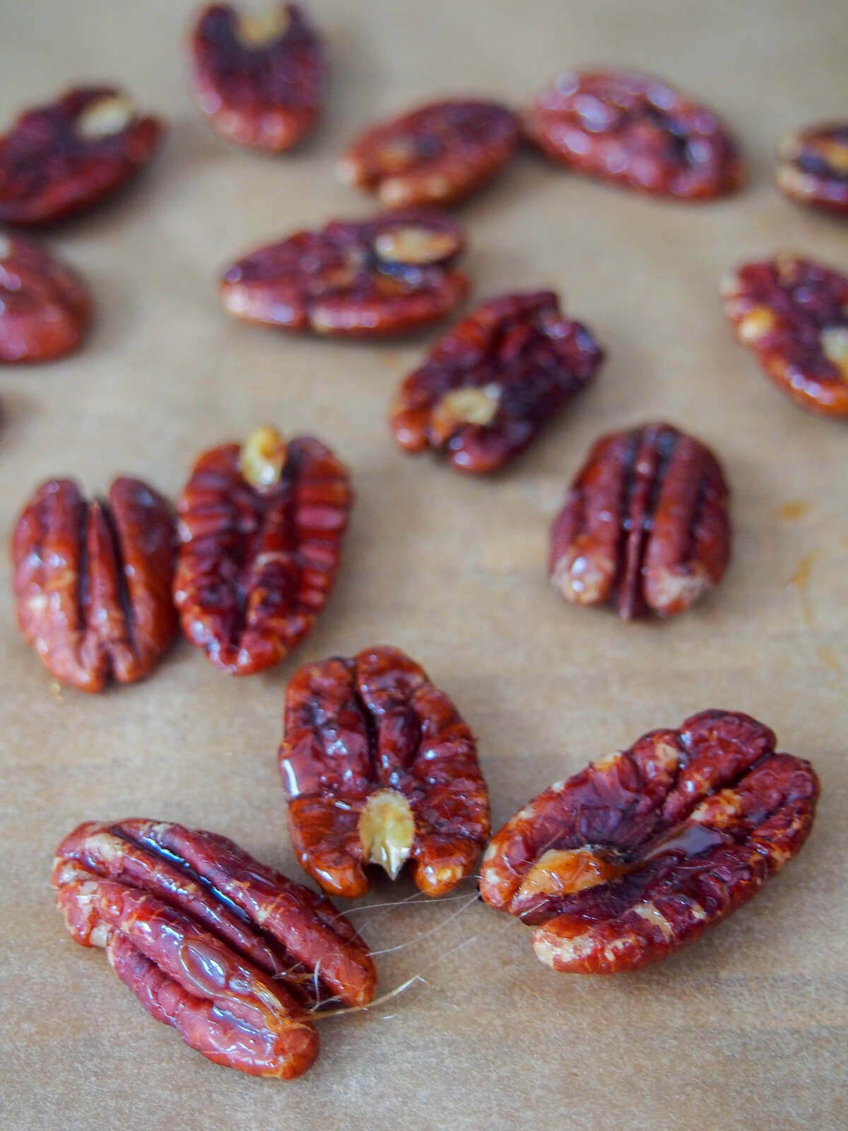 maple candied pecans used to top pear gorgonzola salad maple candied pecans cooling on parchment