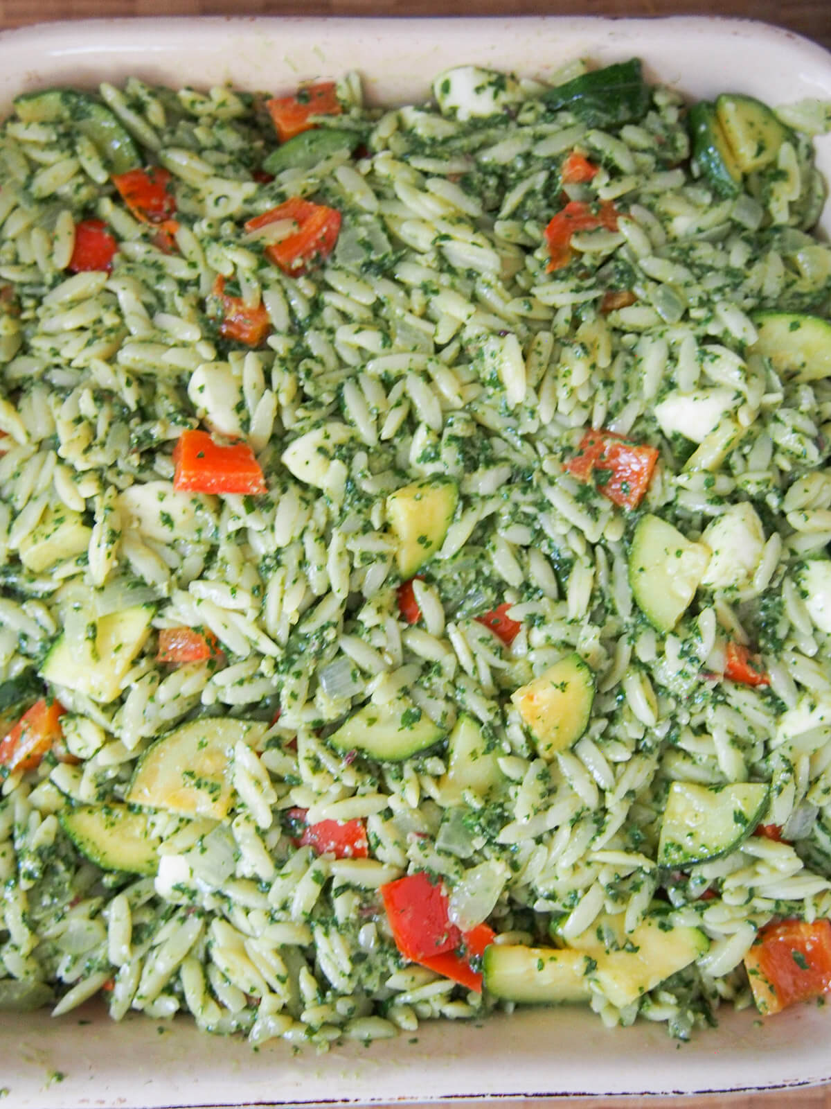 orzo, peso and vegetable mix in baking dish before baking
