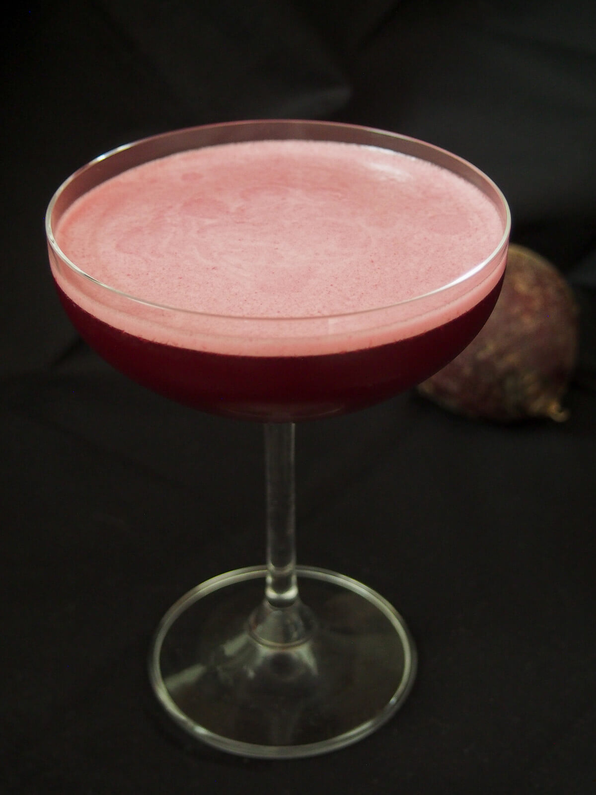 glass of beet negroni sour with foamed top