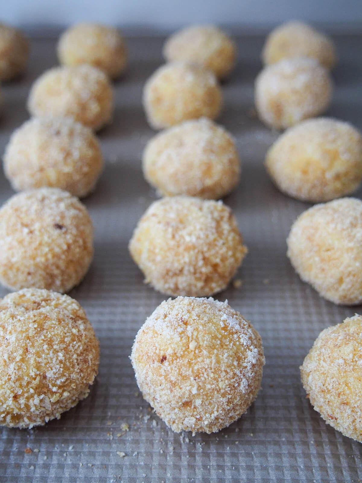 arancini on baking sheet before baking