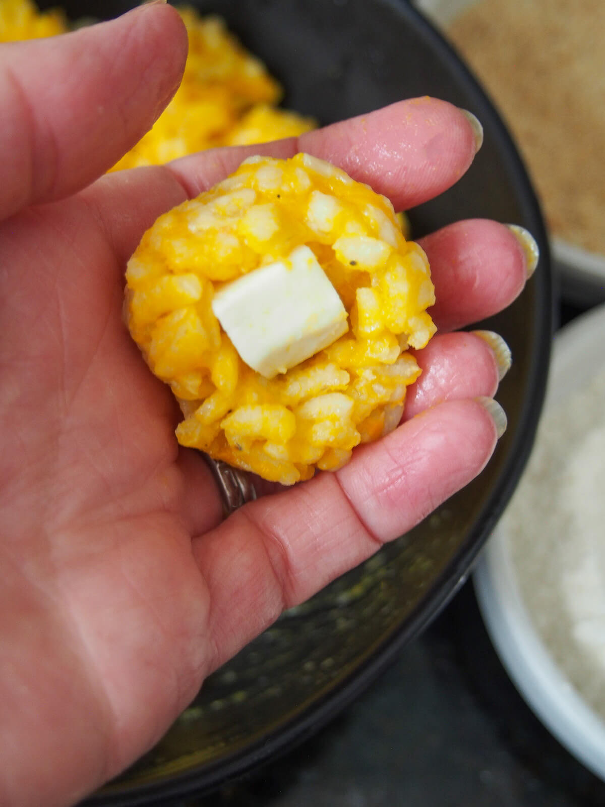 adding a cube of mozzarella to pumpkin risotto
