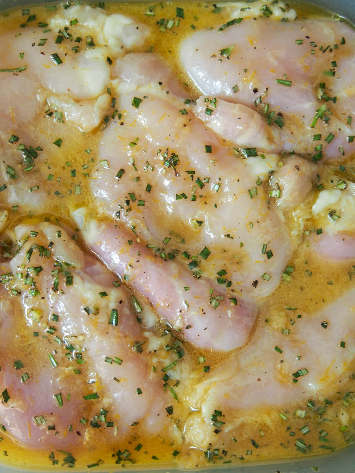 chicken marinading for orange rosemary chicken pieces of chicken in orange and rosemary marinade