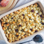 dish of cranberry apple stuffing with spoon below