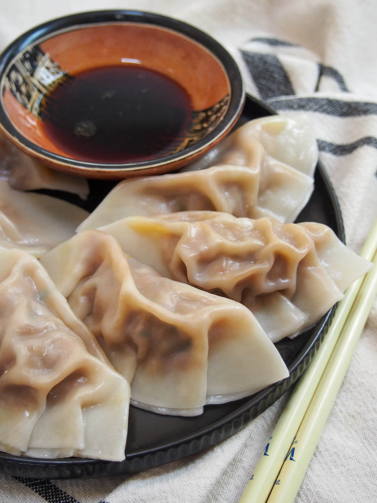 close view of some cumin lamb dumplings on plate