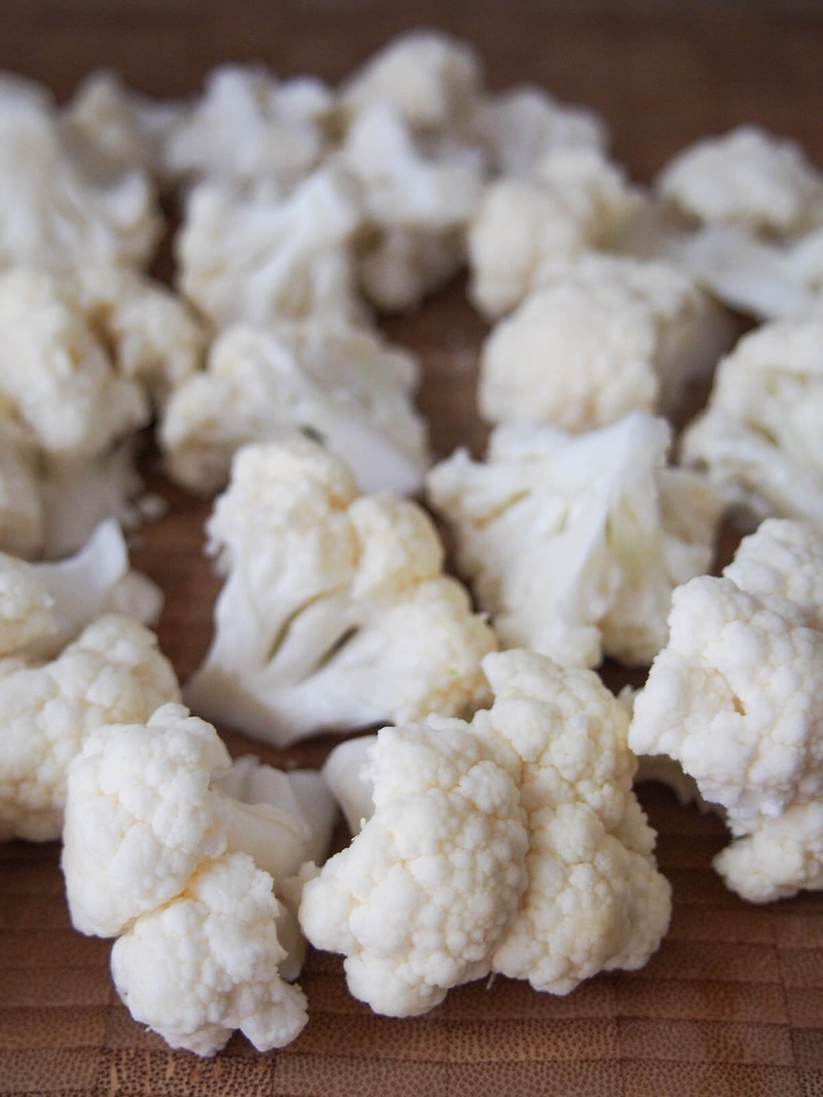 cauliflower florets on chopping board florets of cauliflower on chopping board