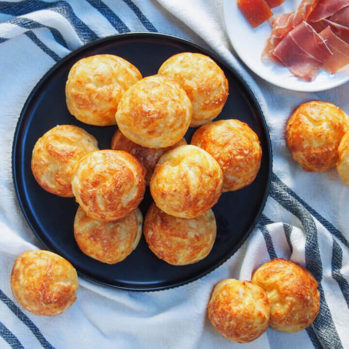 plate of gougeres cheese puffs with a few to side