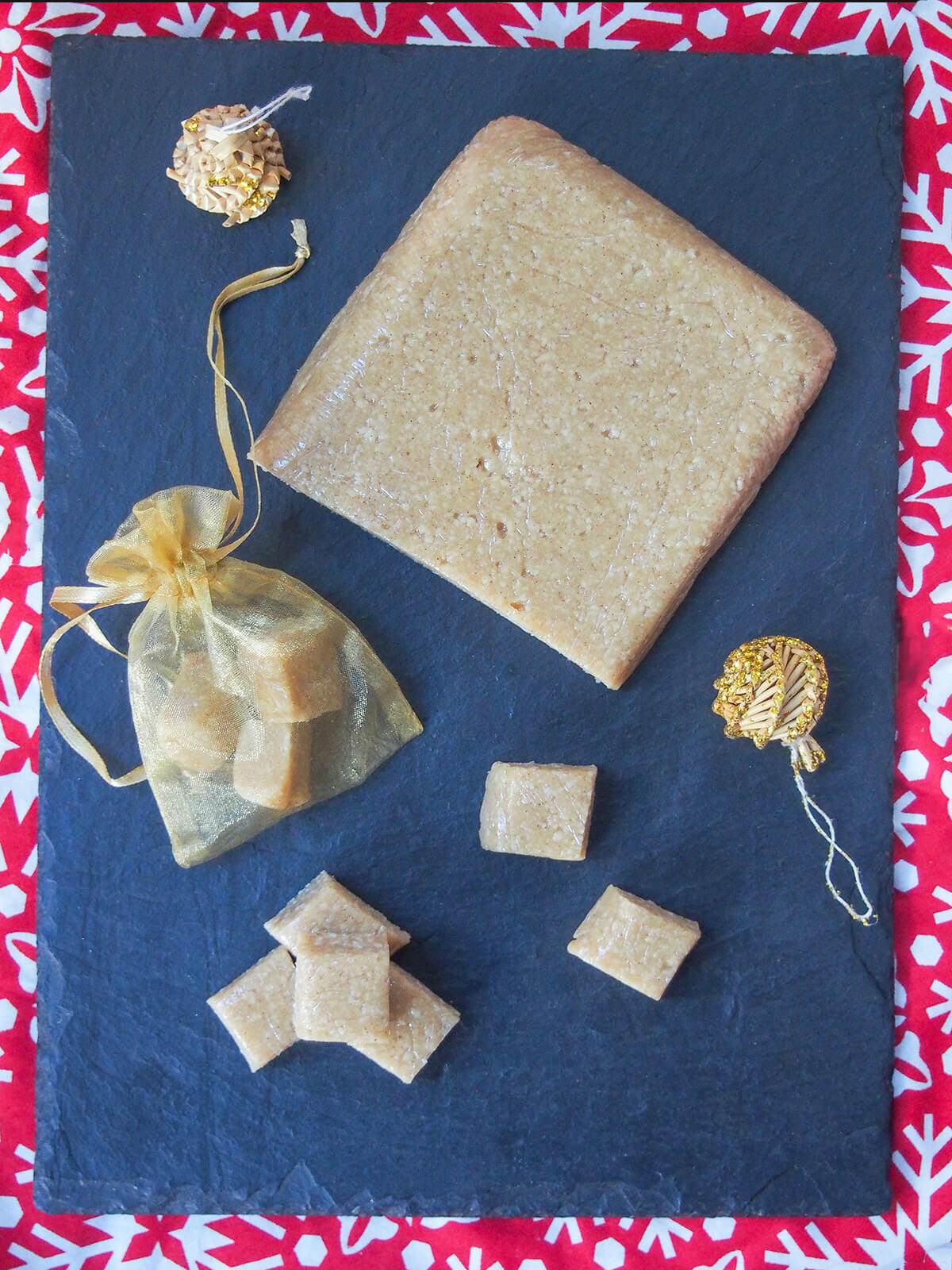 block of turron de Jijona with some squares below and some in golden bag to side