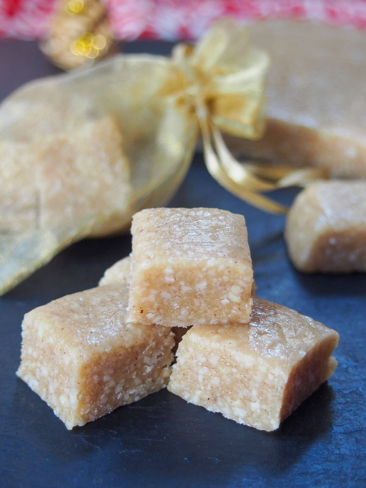 stack of turron de Jijona with golden mesh bag behind