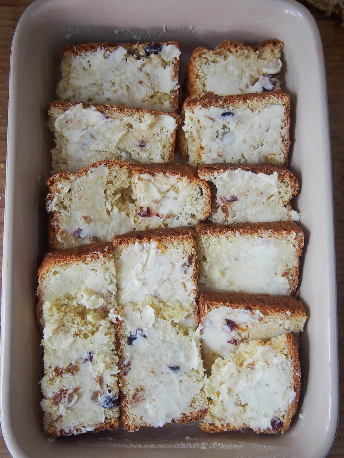 buttered pieces of panettone in baking dish