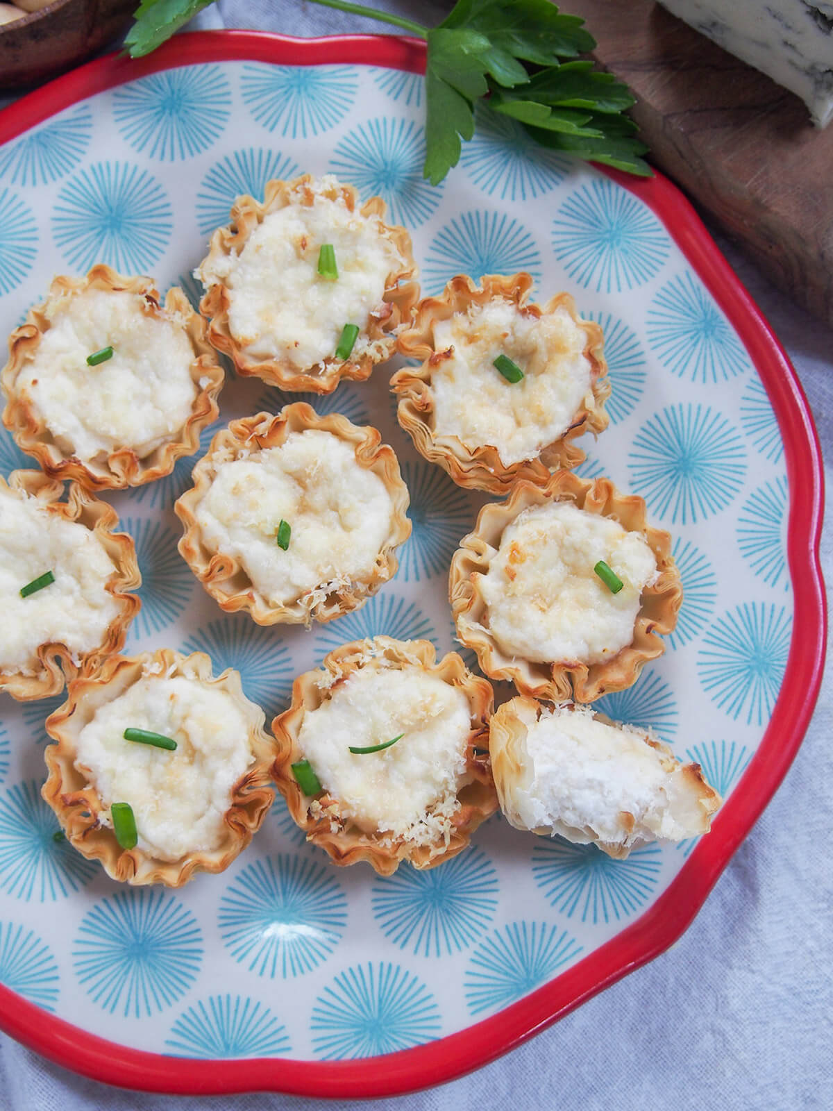 plate of crab phyllo cups from overhead with one bitten into on side