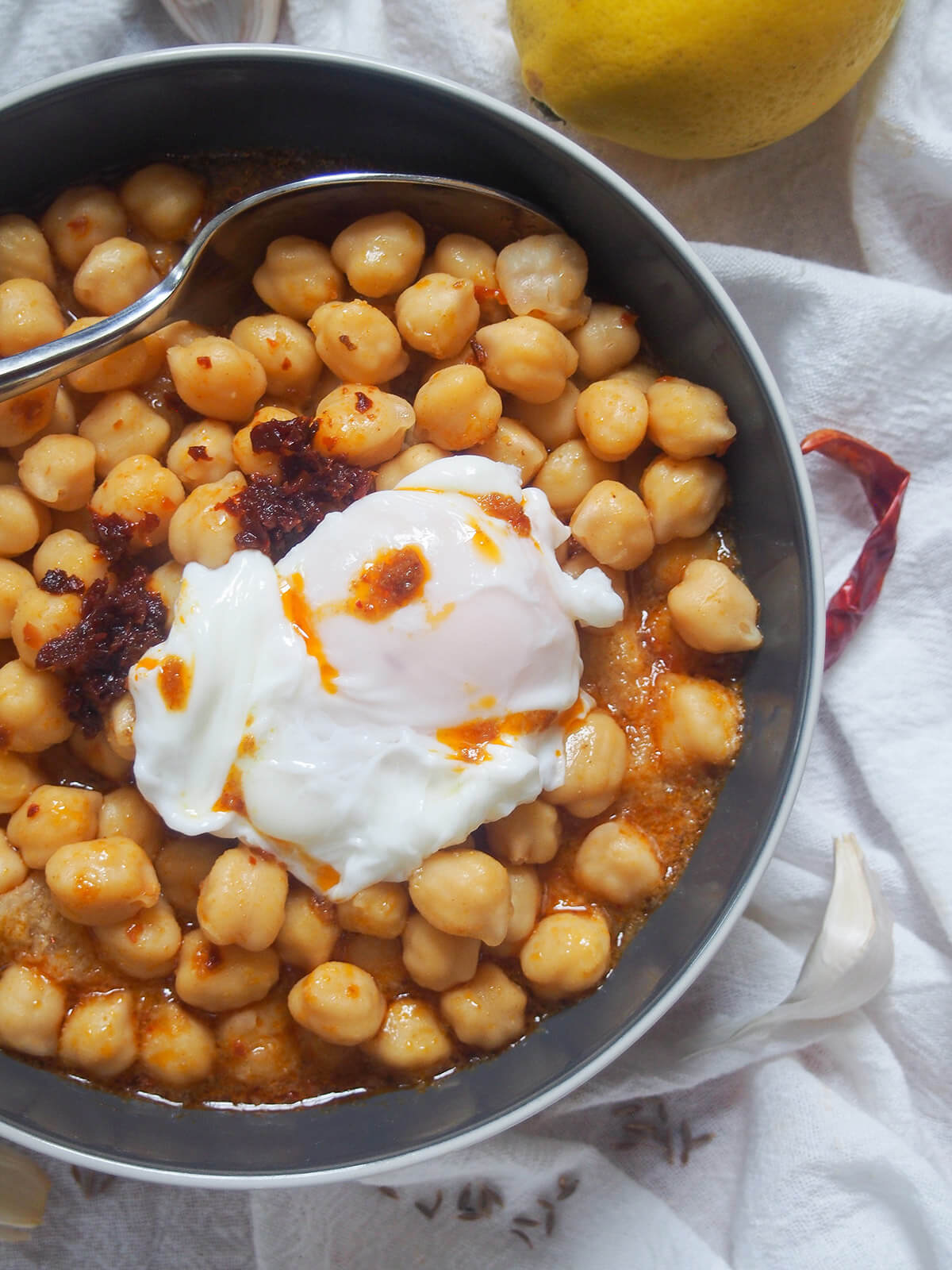 bowl of lablabi chickpea stew with spoon at top of bowl