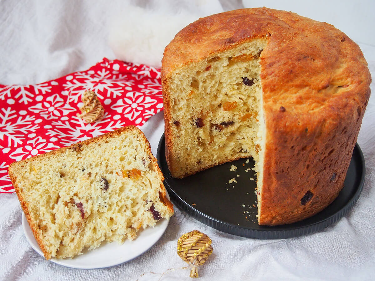 slice of panettone on small plate with rest of loaf on plate to side