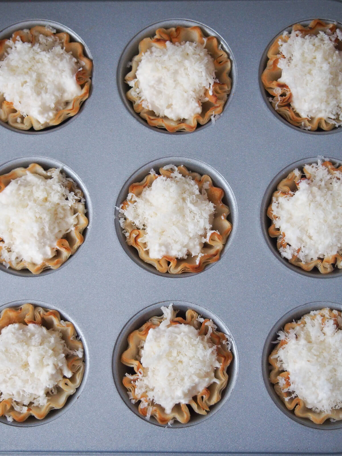 crab phyllo cups in tray before baking