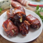 prosciutto wrapped dates on small plate