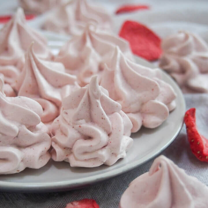 side view of plate of strawberry meringue cookies