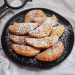 plate of ravioli dolci (sweet ravioli) dusted with powdered sugar