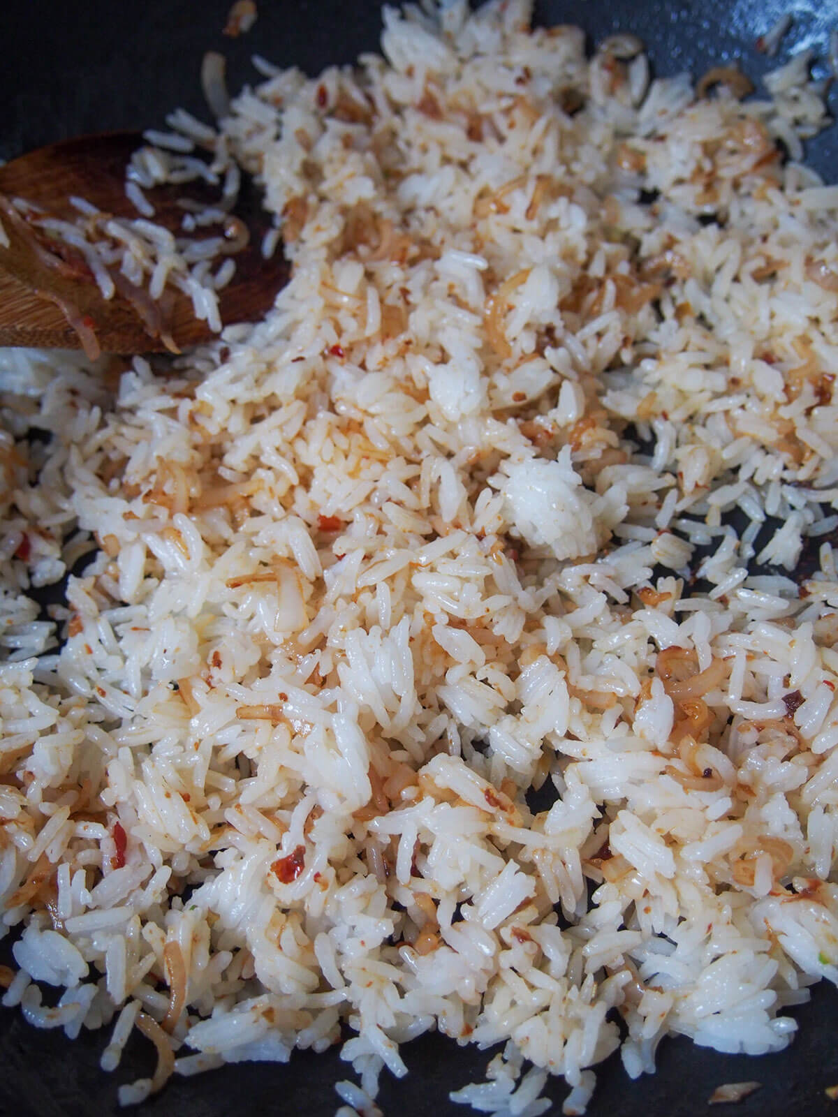 stirring rice with shallot and spices
