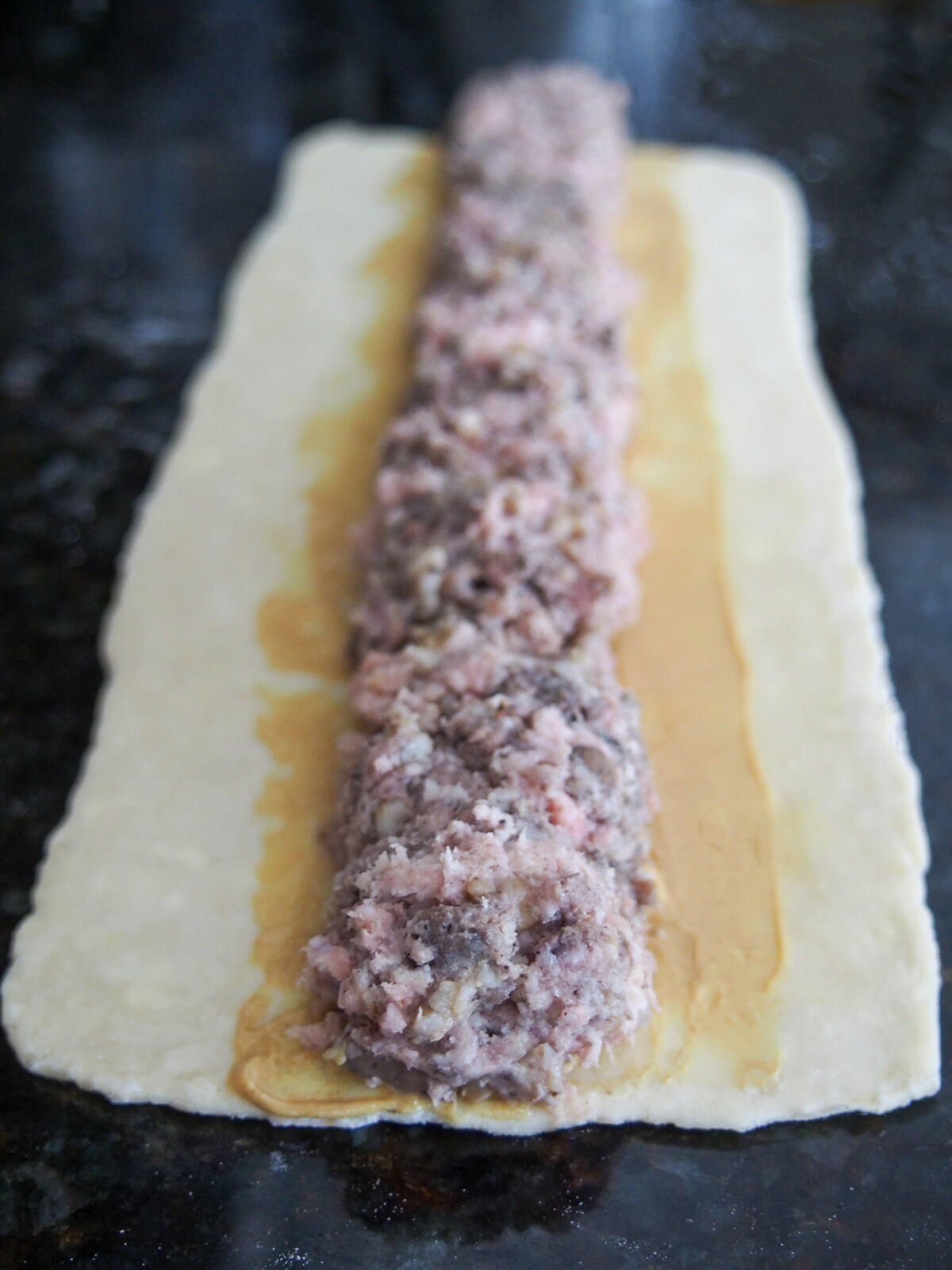pork and haggis mixture on top of pastry