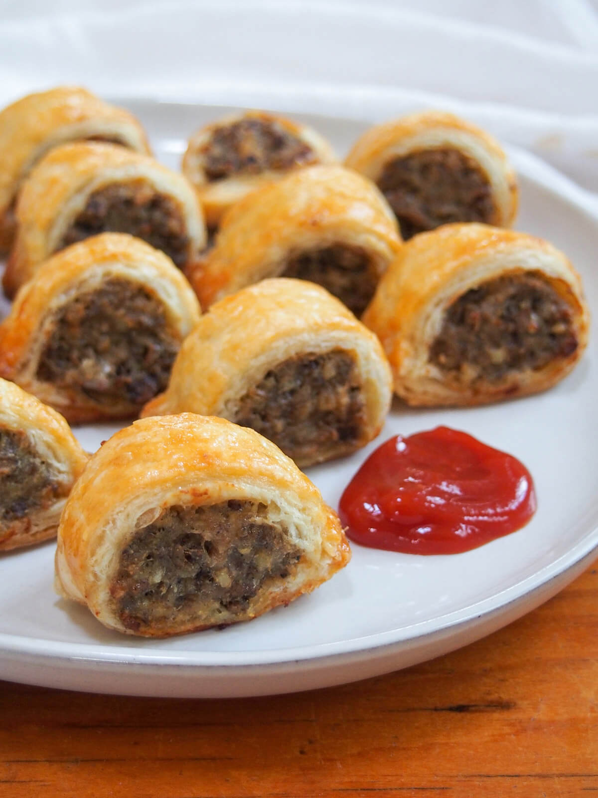 side view of plate of haggis sausage rolls