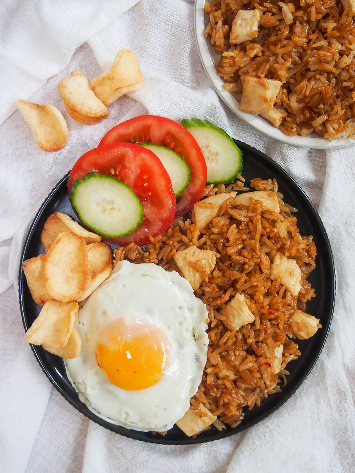 plate of nasi goreng Indonesian fried rice from overhead with shrimp crackers to side