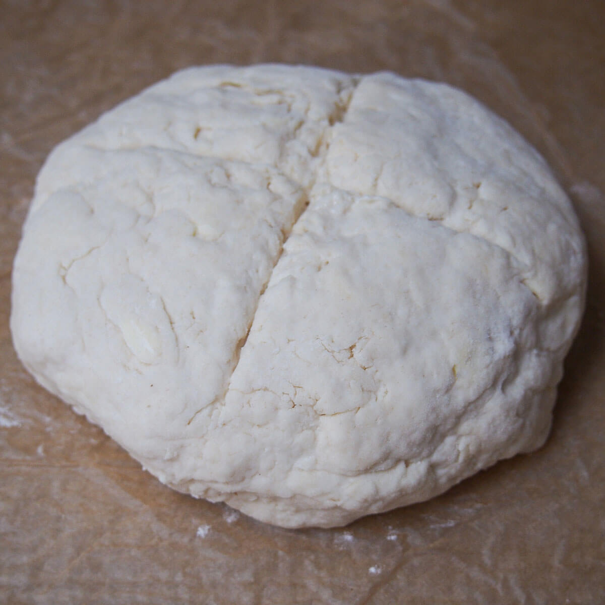 unbaked Australian damper bread on baking sheet formed bread on baking sheet before baking
