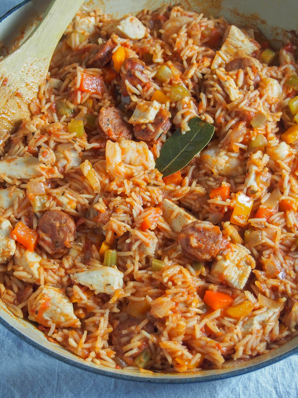 close up view of dish of Creole jambalaya with bay leaf on top