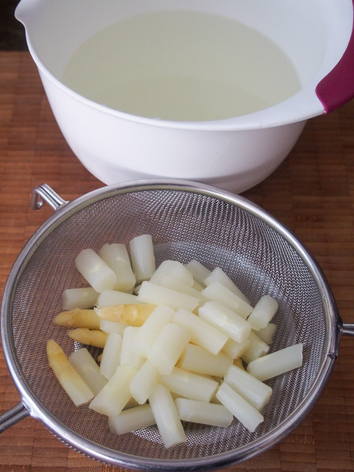 drained asparagus chunks and stock behind
