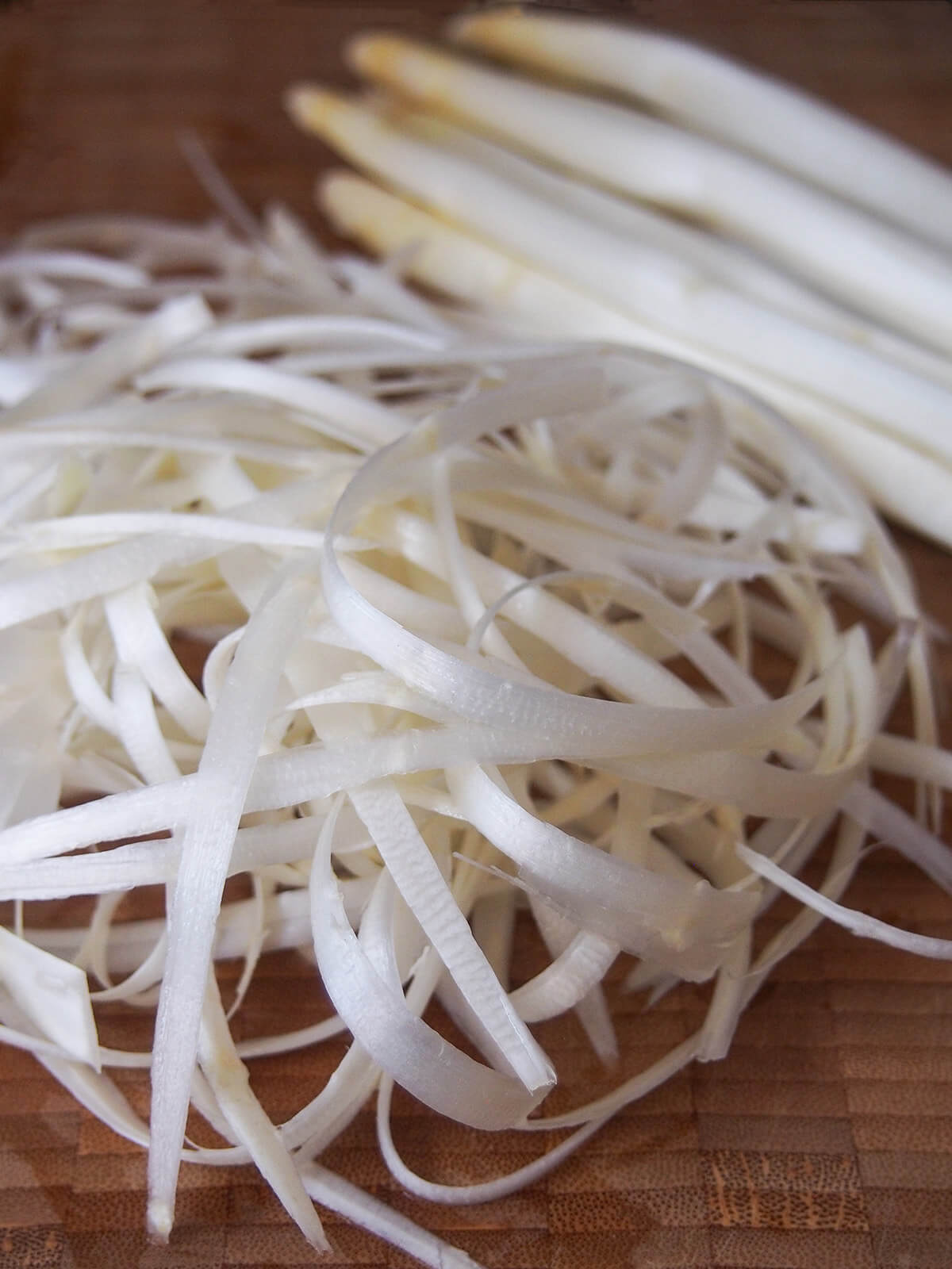 peelings from white asparagus in front of spears