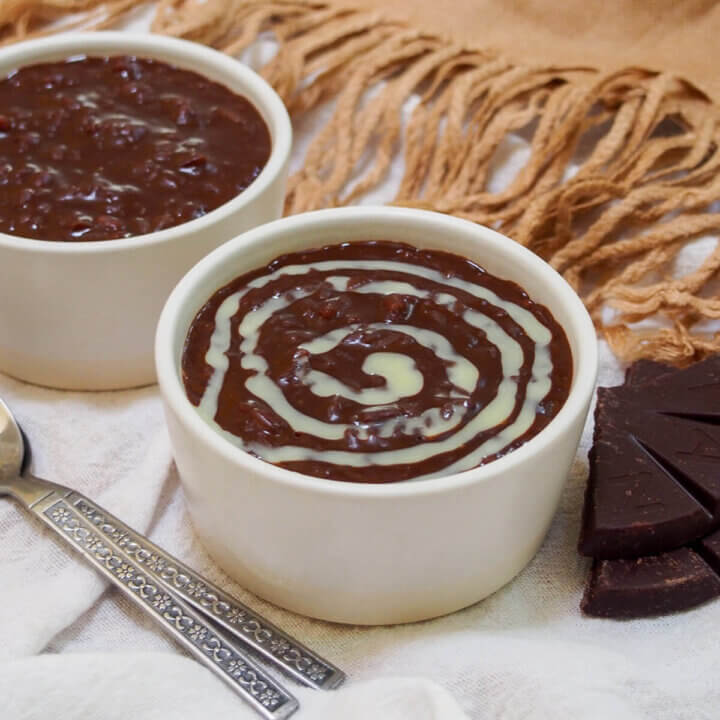 bowl of champorado - Filipino chocolate rice porridge with pieces of chocolate to side