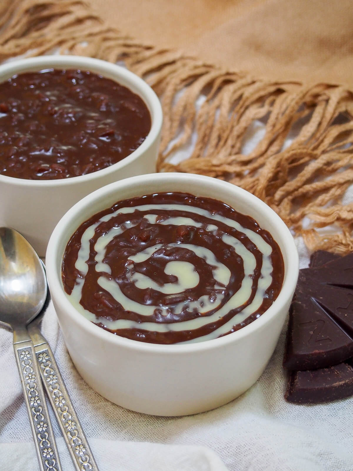 dish of champorado topped with swirl of condensed milk
