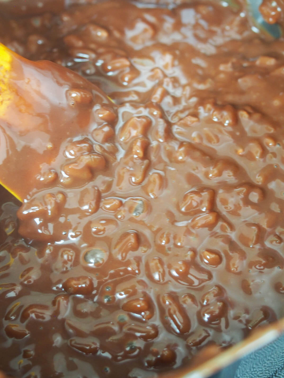 stirring pot of champorado - Filipino chocolate rice porridge
