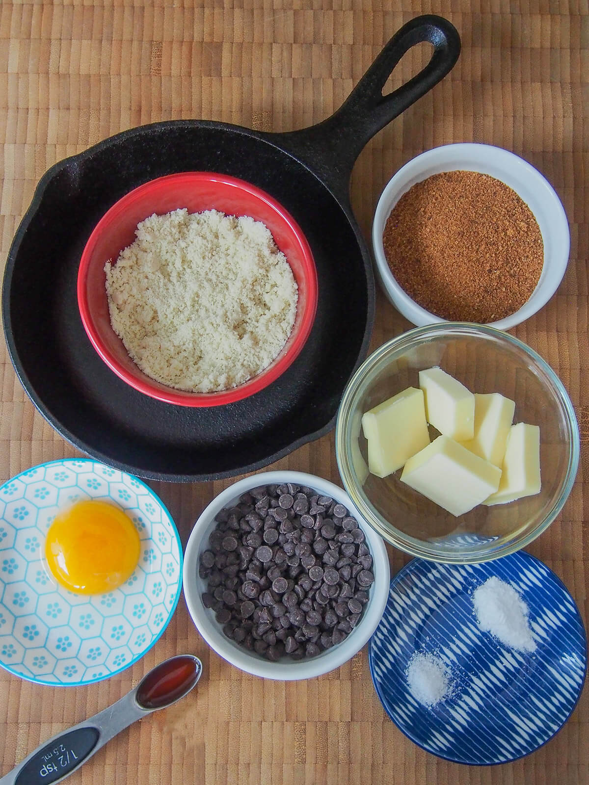 bowls with almond flour, butter, coconut sugar, chocolate chips and egg yolk