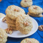 Persian walnut cookie resting on stack with more cookies behind