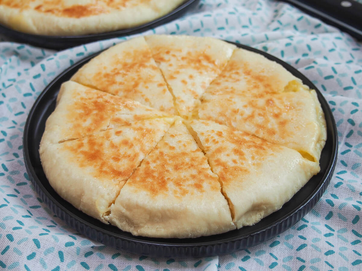 imeruli khachapuri on black plate