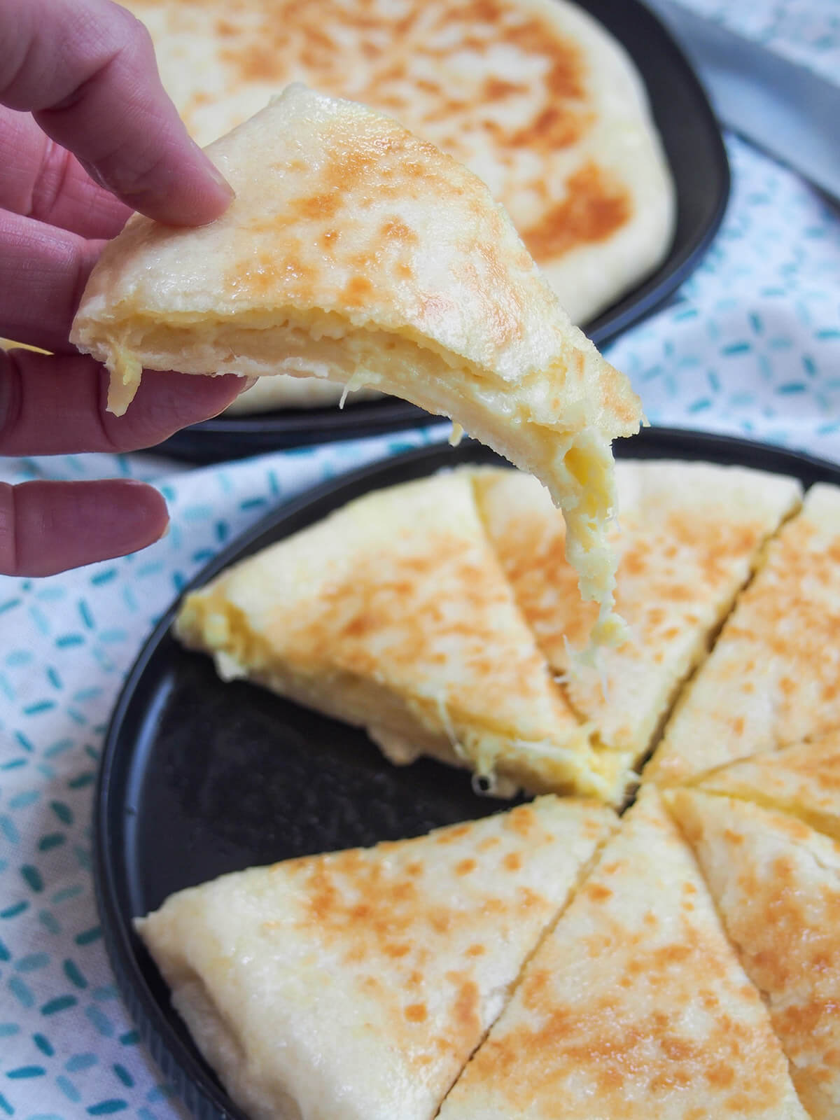 lifting slice of imeruli khachapuri from plate