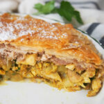 side view of pastilla Moroccan pie in dish showing layers of filling