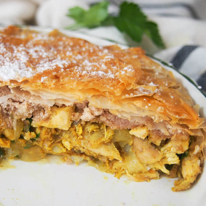 side view of pastilla Moroccan pie in dish showing layers of filling