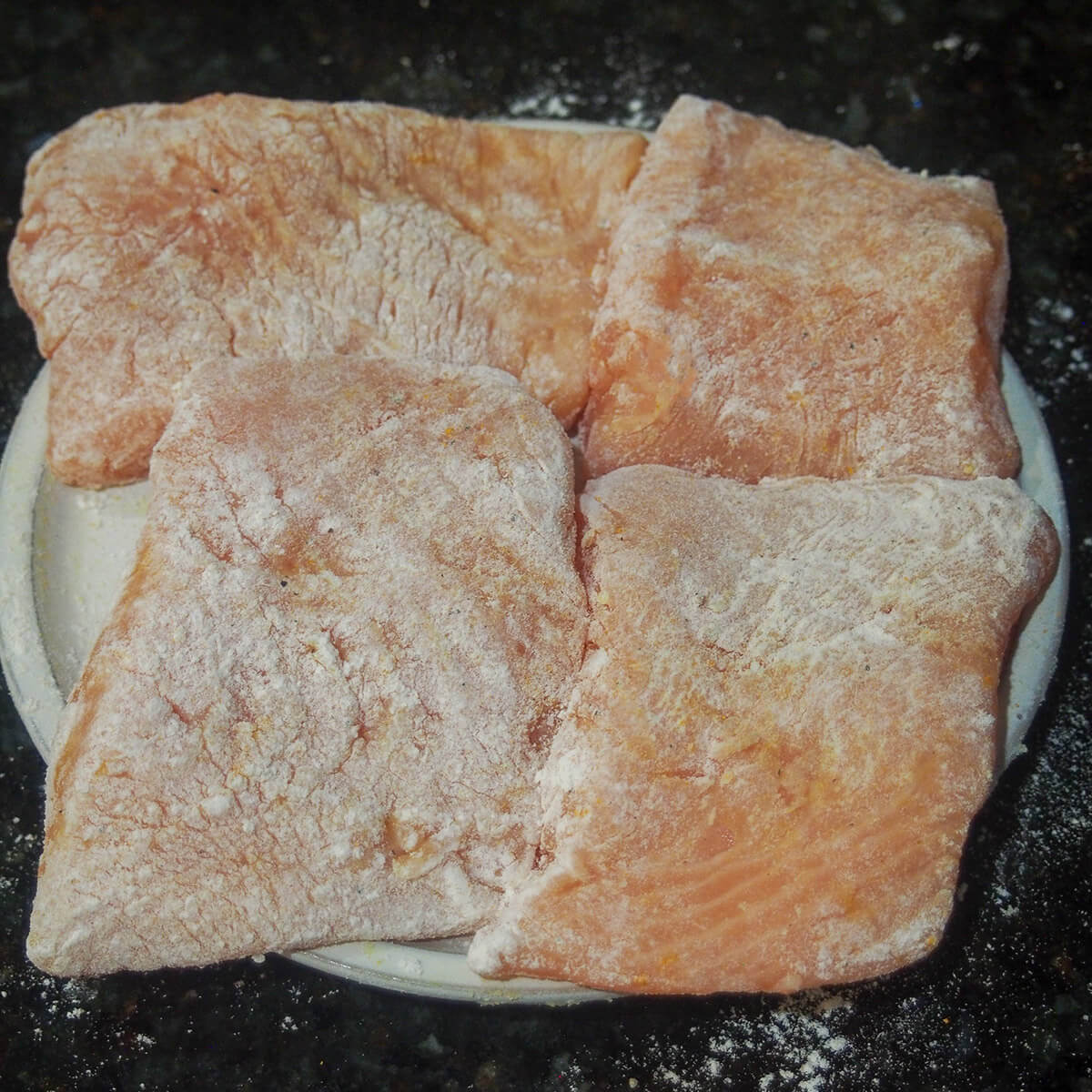pieces of salmon dusted with seasoned flour