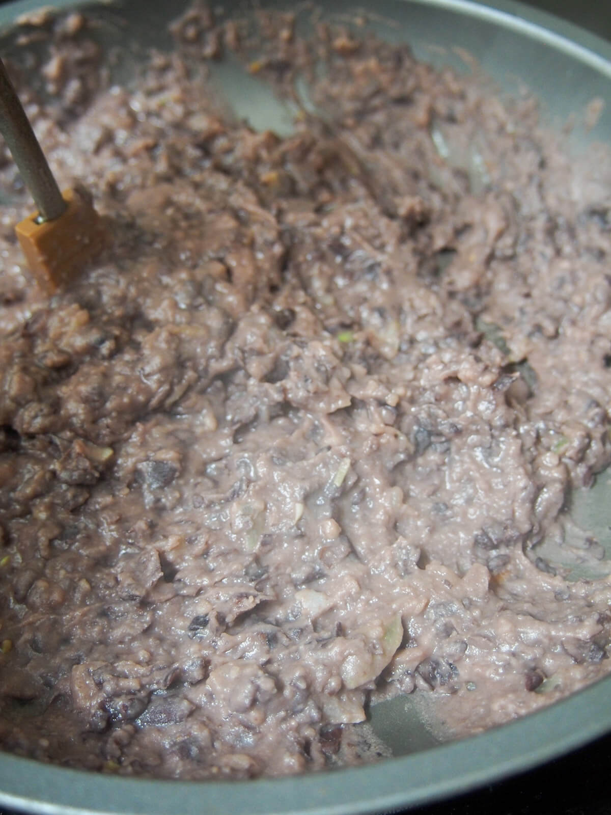 well mashed black beans in skillet