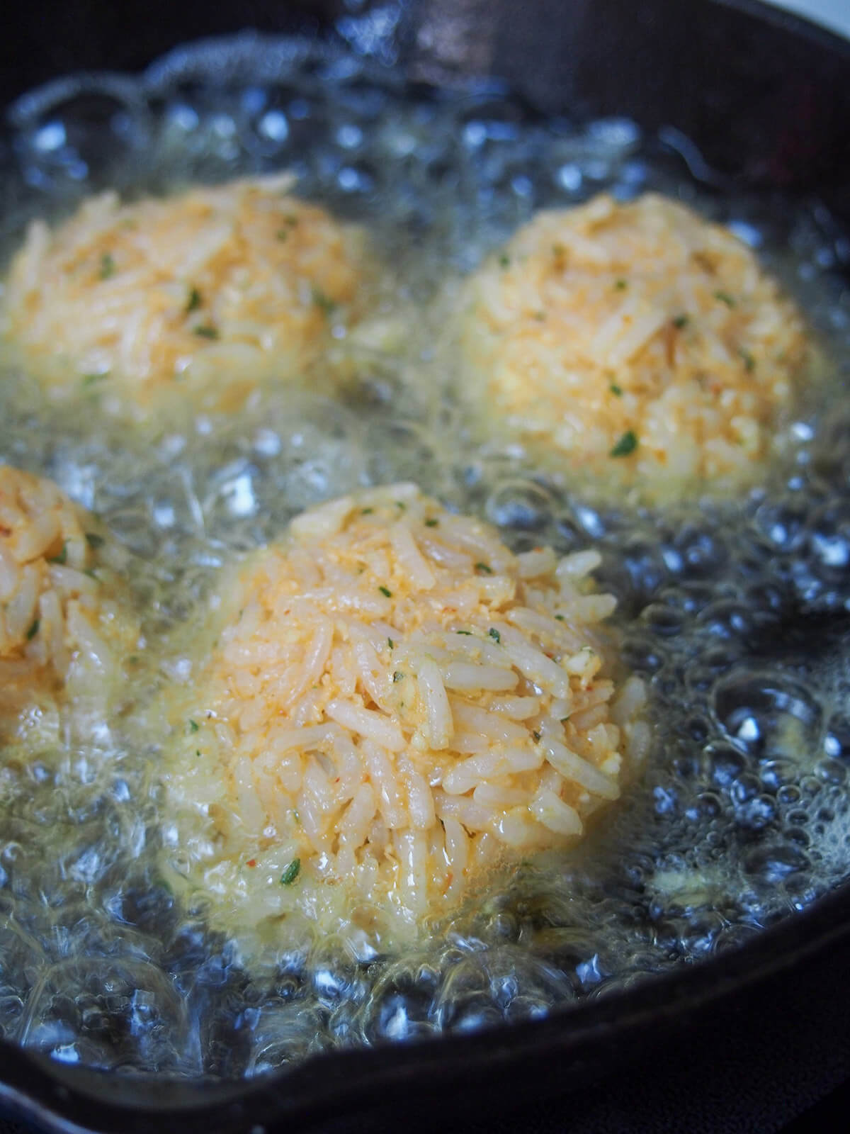 frying balls of rice in oil
