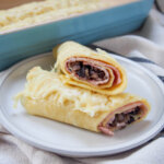 part of a ficelle picarde ham crepe sitting on top of other half showing filling inside
