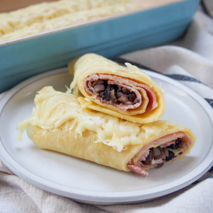 part of a ficelle picarde ham crepe sitting on top of other half showing filling inside