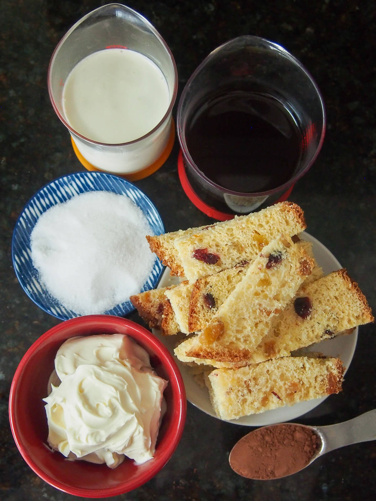 measures with cream, coffee, bowls of mascarpone, sugar, with sticks of panettone to side.